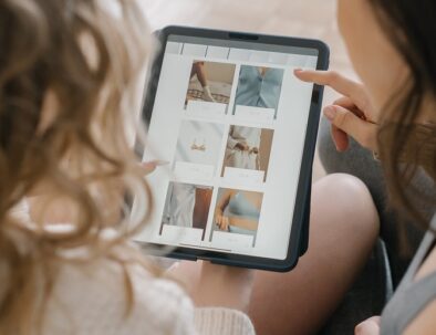 women scrolling through a tablet computer